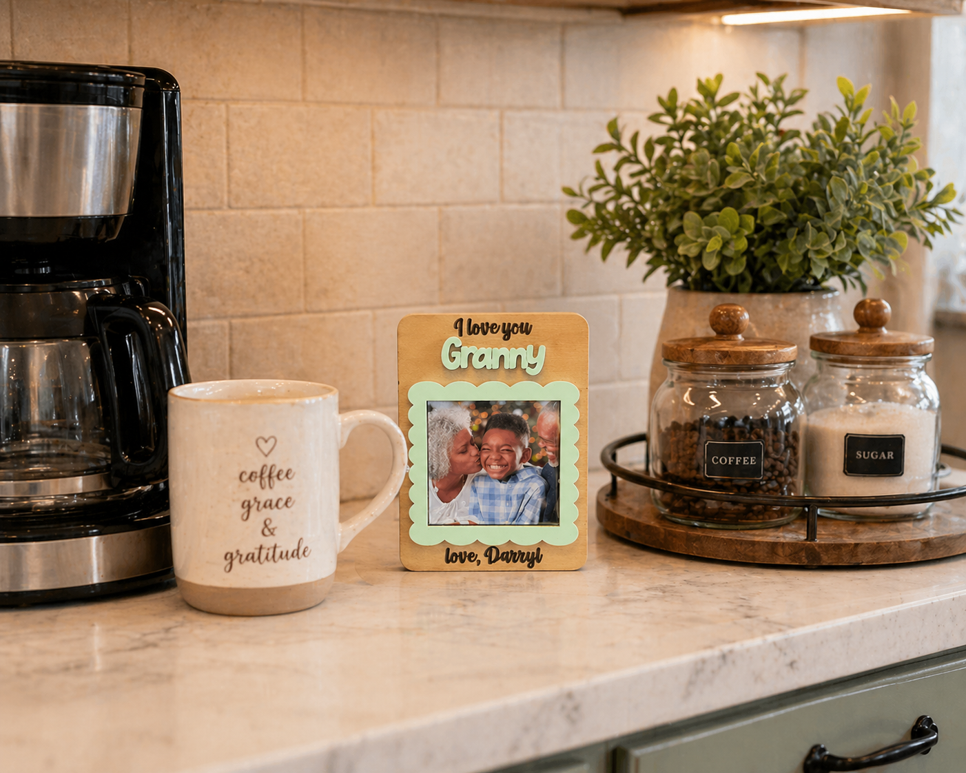 Kitchen counter with coffee maker, mug, photo frame, and jars.