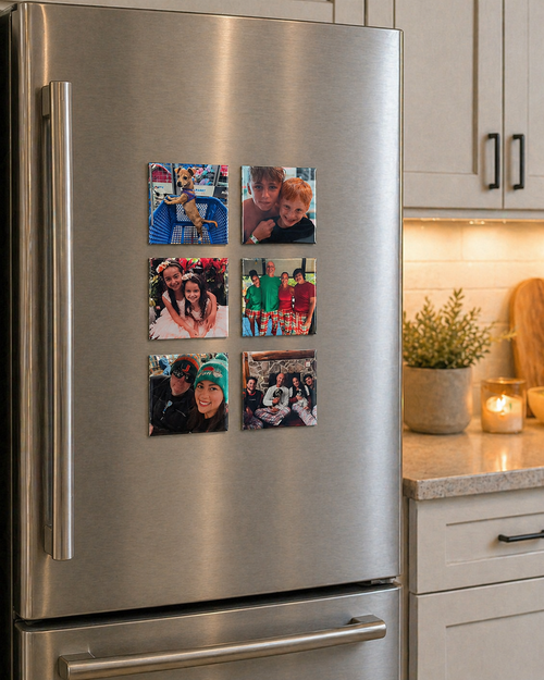 Stainless steel refrigerator with family photos as magnets in a kitchen setting